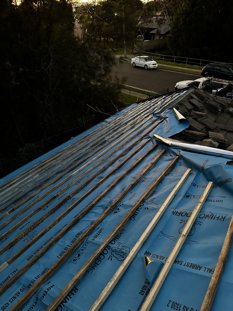 a roof with blue tarp covering