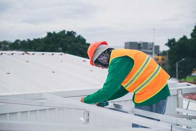 Man Working on metal roof